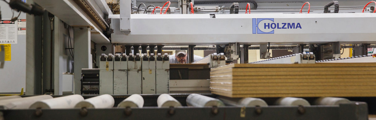 Man peers through Holzma machine